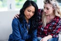 Young woman consoling depressed female friend Royalty Free Stock Photo