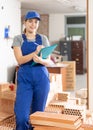 Young woman construction worker standing inside apartment Royalty Free Stock Photo