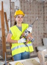 Young woman construction worker standing inside apartment Royalty Free Stock Photo