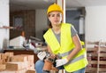 Young woman construction worker standing inside apartment Royalty Free Stock Photo