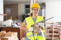 Young woman construction worker standing inside apartment Royalty Free Stock Photo