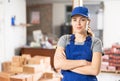 Young woman construction worker standing inside apartment Royalty Free Stock Photo