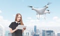 Young woman controlling a drone in big city Royalty Free Stock Photo