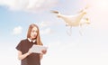 Young woman controlling a drone on bright day Royalty Free Stock Photo