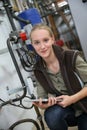 Young woman controlling water level in plumbery Royalty Free Stock Photo