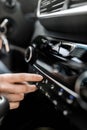 Interior view of a modern new car. Woman`s hand and climatronic or air conditioner system concept. Royalty Free Stock Photo