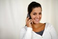 Young woman conversing on mobile phone looking you Royalty Free Stock Photo