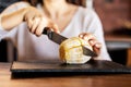 The girl cut the orange with a knife Royalty Free Stock Photo