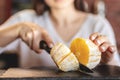 The girl cut the orange with a knife Royalty Free Stock Photo
