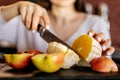 The girl cut the orange with a knife Royalty Free Stock Photo