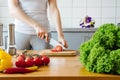 Young woman cooking healthy meal in the kitchen