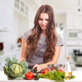 Young Woman Cooking in the kitchen. Healthy Food - Royalty Free Stock Photo