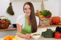 Young woman cooking in kitchen. Householding, tasty food and vegetarian in lifestyle concepts Royalty Free Stock Photo