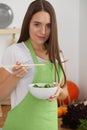 Young woman cooking in kitchen. Householding, tasty food and vegetarian in lifestyle concepts Royalty Free Stock Photo