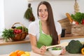 Young woman cooking in kitchen. Householding, tasty food and vegetarian in lifestyle concepts Royalty Free Stock Photo