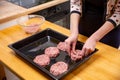 Young woman cooking meatballs or cutlets in modern kitchen Royalty Free Stock Photo