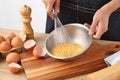 Young woman cooking omelet on table Royalty Free Stock Photo