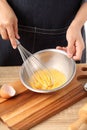 Young woman cooking omelet on table Royalty Free Stock Photo