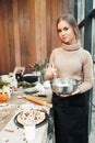 Young woman cooking pie with dried fruits Royalty Free Stock Photo