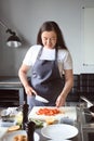 Young woman cooking in restaurant kitchen during cooking classes Royalty Free Stock Photo