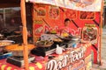 A young woman is cooking seafood to sell to visitors who come to the city park