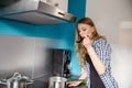 Young woman cooking and tasting dinne Royalty Free Stock Photo