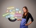 Young woman cooking vitamins and minerals Royalty Free Stock Photo