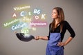 Young woman cooking vitamins and minerals Royalty Free Stock Photo