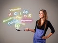 Young woman cooking vitamins and minerals Royalty Free Stock Photo