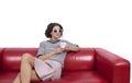 Young woman on a couch posing with a cup of coffee