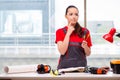 The young woman in coveralls doing repairs Royalty Free Stock Photo