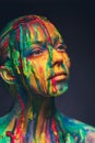 Young woman covered with a colourful paint