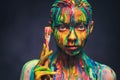 Young woman covered with a colourful paint