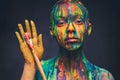 Young woman covered with a colourful paint