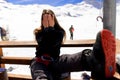 Young woman covered his face with her hands with mountain view during ski vacation in Alps backgrounds Royalty Free Stock Photo