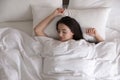 Young woman covered with warm white blanket sleeping in bed, top view Royalty Free Stock Photo