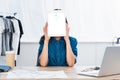 young woman covering face by digital tablet with skype application