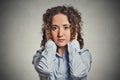 Young woman covering her ears with hands