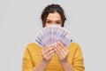 Young woman covering her face with euro money Royalty Free Stock Photo