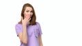 Young woman covering mouth with hand, looking serious, promises to keep secret. Place for your text Royalty Free Stock Photo