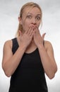 Young woman covering mouth with her hands Royalty Free Stock Photo