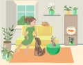 Young woman in cozy room with her pets. Dog, cat and gold fish are her friends. Home plants decorate room Royalty Free Stock Photo