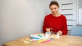 Young woman creating her Feng Shui wish map using scissors. Dreams and wishes. Royalty Free Stock Photo