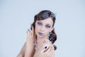 Young woman in creative image with silver artistic make-up.Holiday Make-up.Beautiful Woman`s Face.Winter Christmas lips