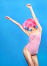 Young woman with creative pop art make up and pink wig looking at the camera on blue background Royalty Free Stock Photo