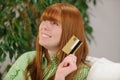 Young woman with credit card smiling Royalty Free Stock Photo