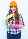 Young woman with crossed arms holding painting roller Royalty Free Stock Photo