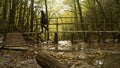 Young woman crossing a river using a bridge