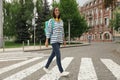 Young woman crossing street. Traffic rules Royalty Free Stock Photo