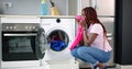 Young Woman Crouching With Cleaned Clothes Royalty Free Stock Photo